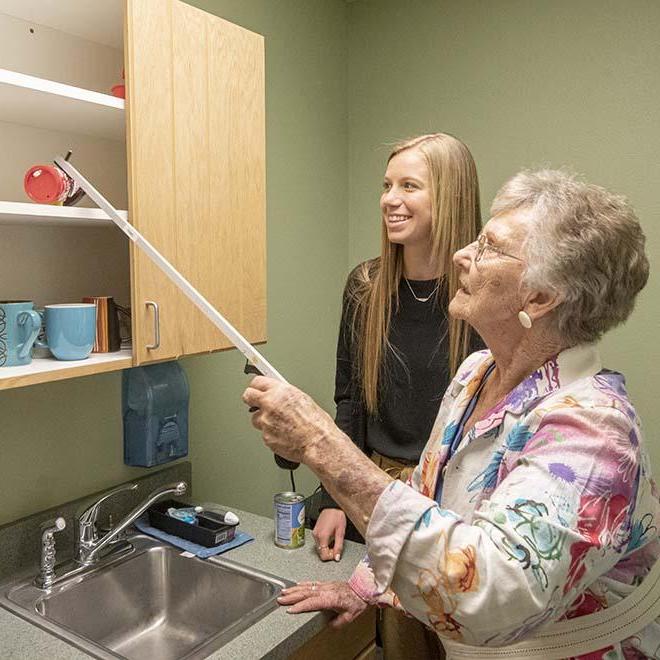 Occupational Therapy student working with elderly patient at pro bono clinic