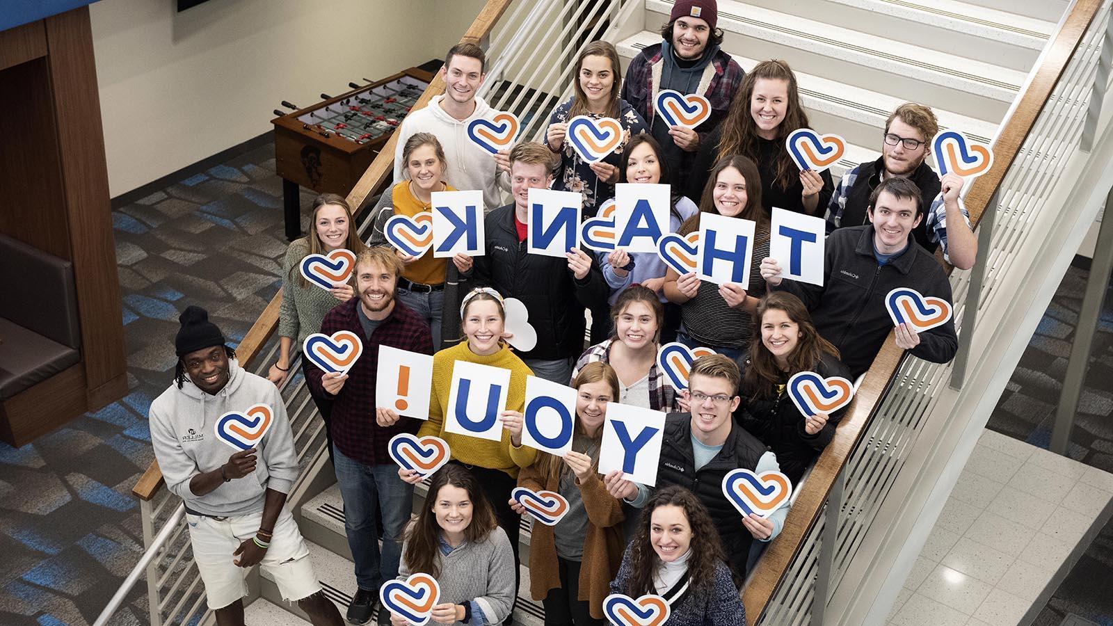 Group of University of Mary students holding letters that spell out “thank you!”